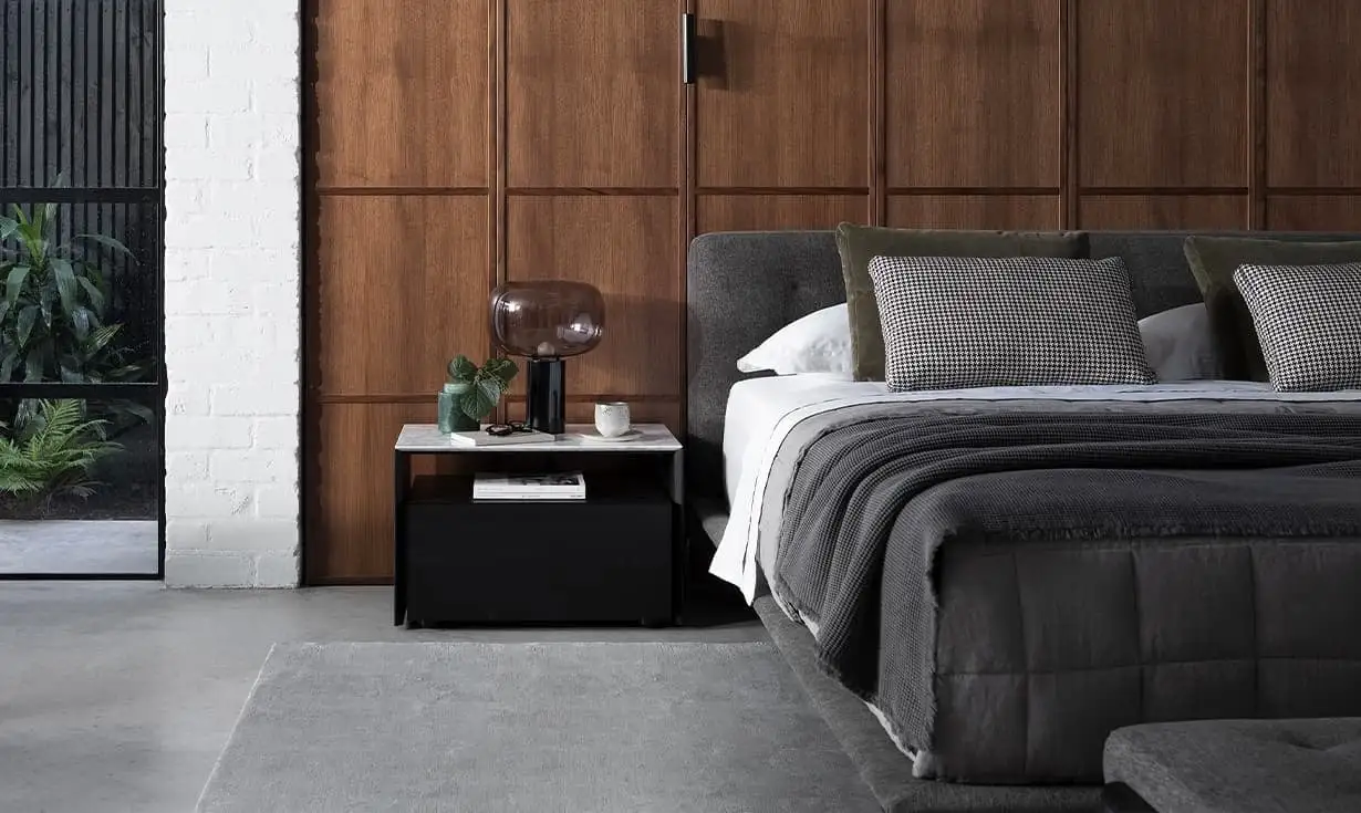 Bright small bedroom with large window, white rug, and mustard accents.