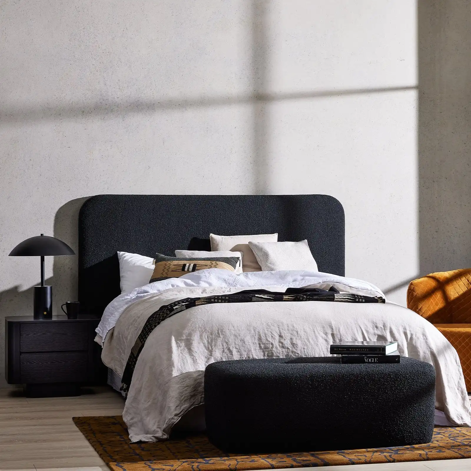 Modern small bedroom with wooden slat wall and floating nightstands.