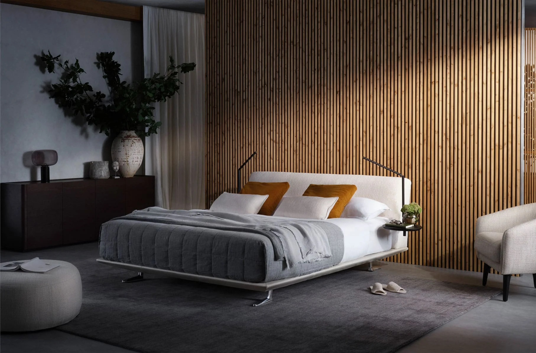 Serene small bedroom with neutral beige bed and sleek hidden storage.