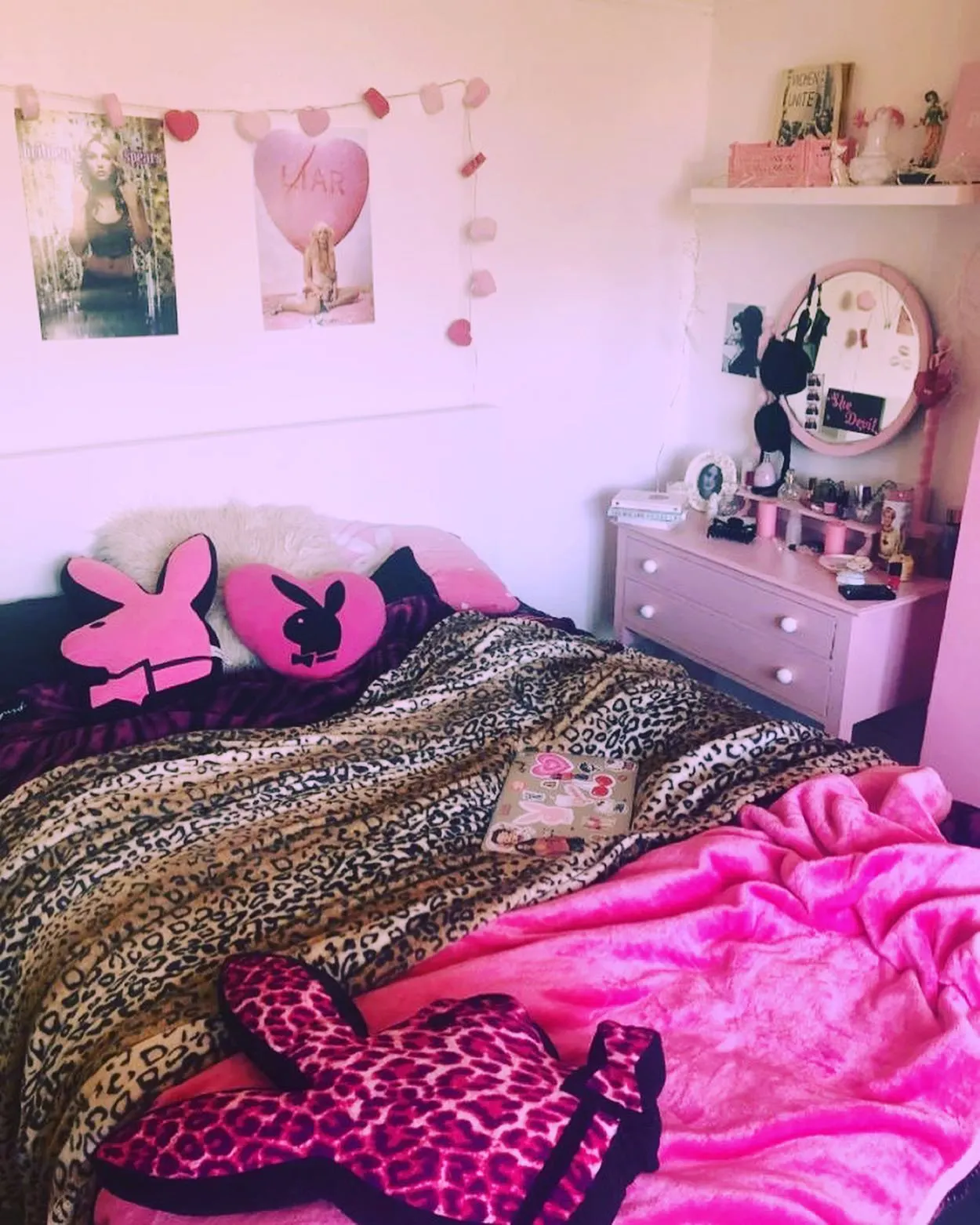 Y2K Bedroom Ideas for Teenage Girls: Pink bunny pillows on leopard print bed.