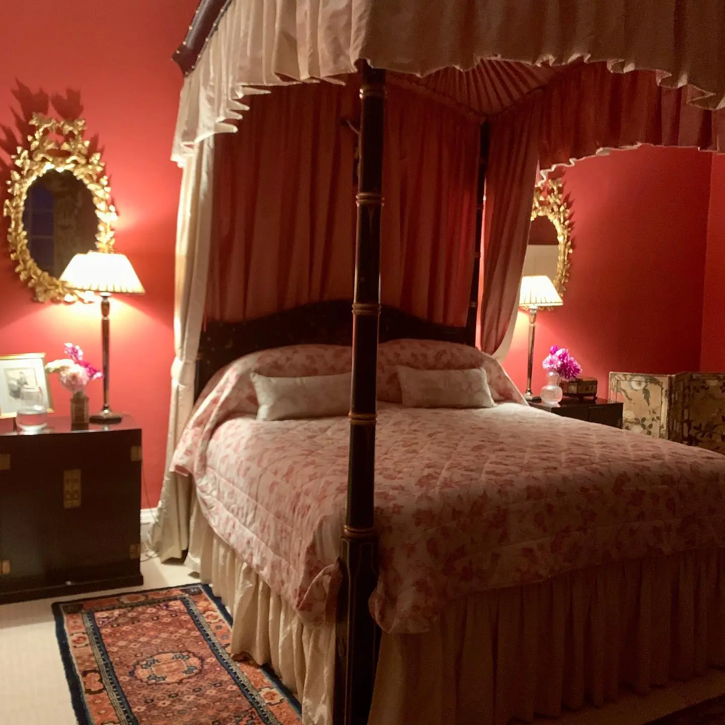 Romantic red bedroom with canopy bed.
