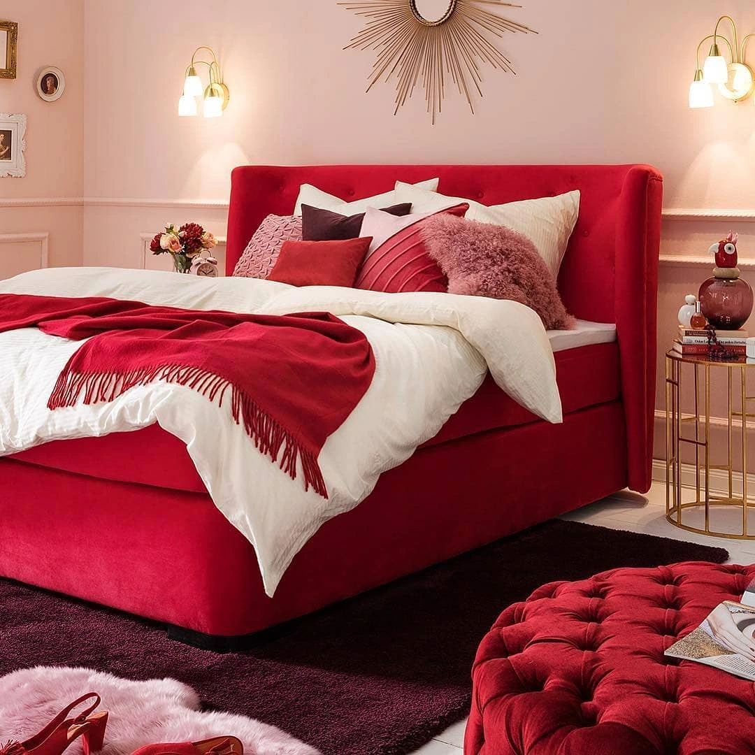 Red velvet bed with pink walls.