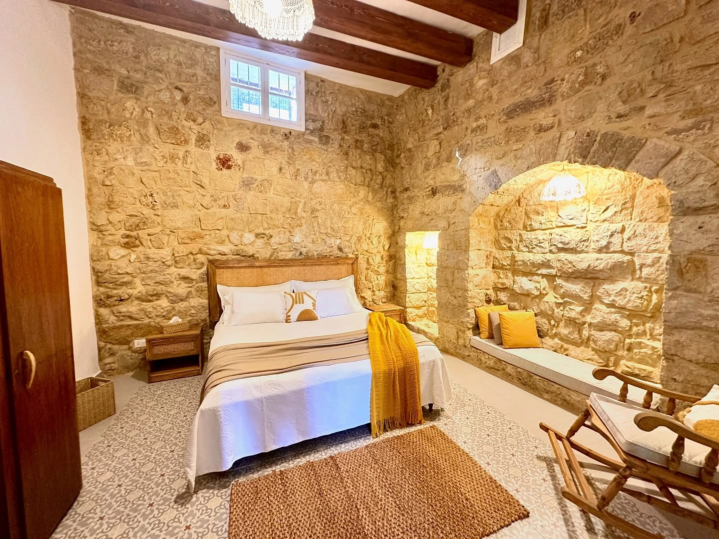 Rustic bedroom with stone walls and wooden furniture