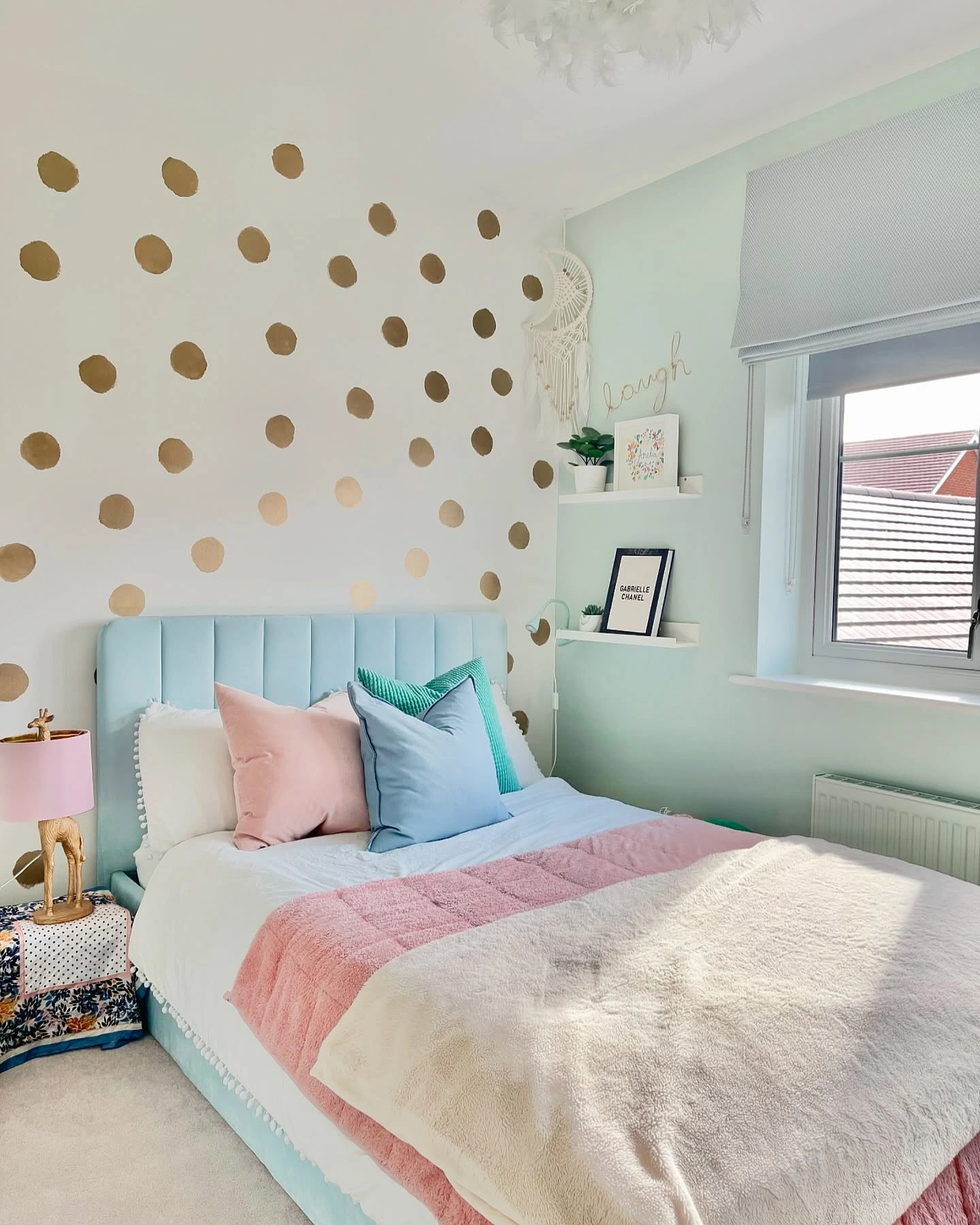 Bedroom with gold polka dot wall and pastel colors