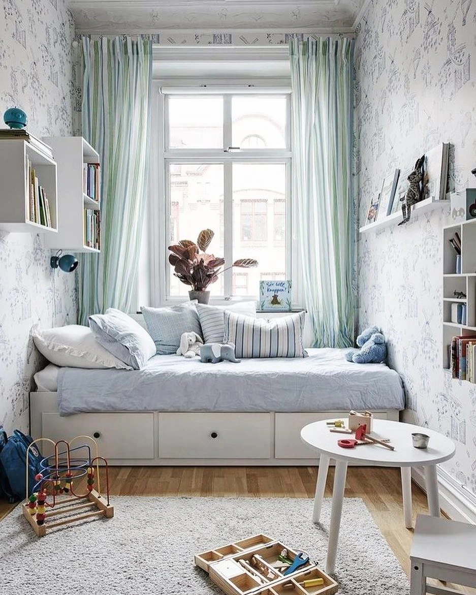 Kid's room with a daybed, drawer storage, and light blue decor.