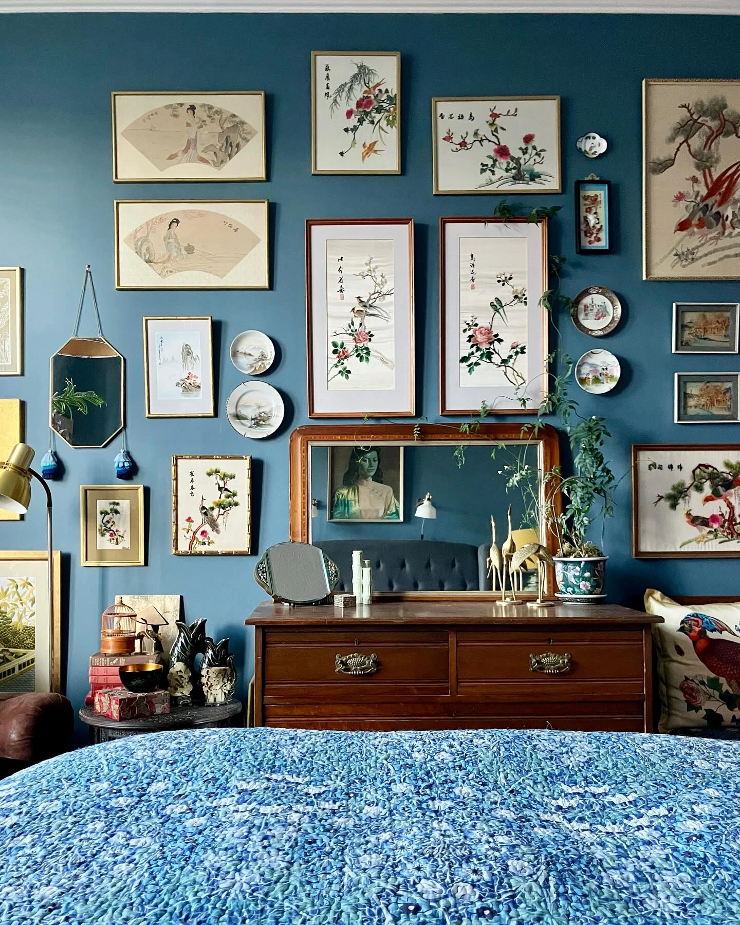 Large gallery wall above a wooden dresser.  