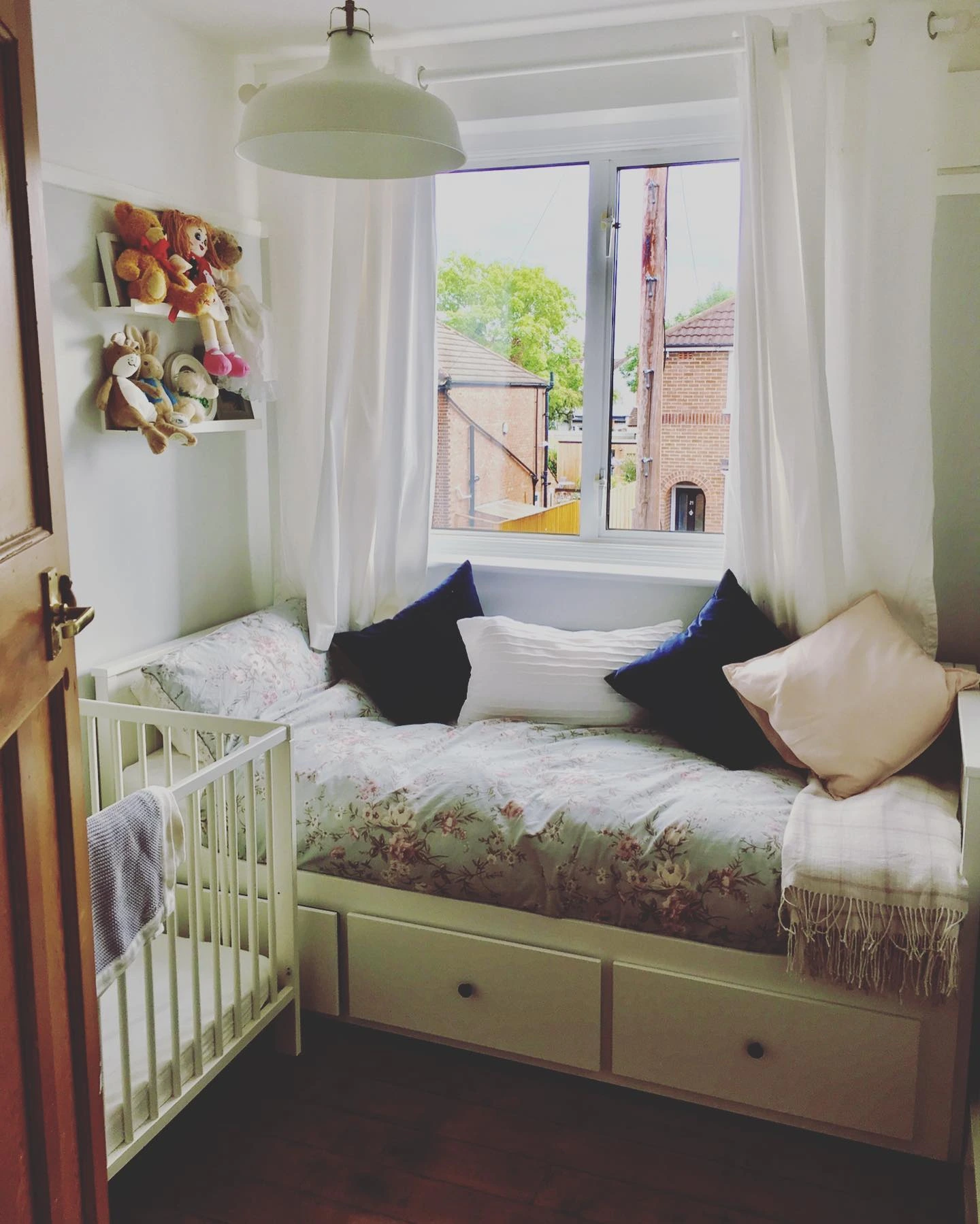 Corner bed with floral bedding.