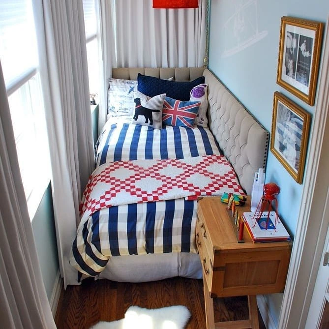 Bed against wall with striped bedding.
