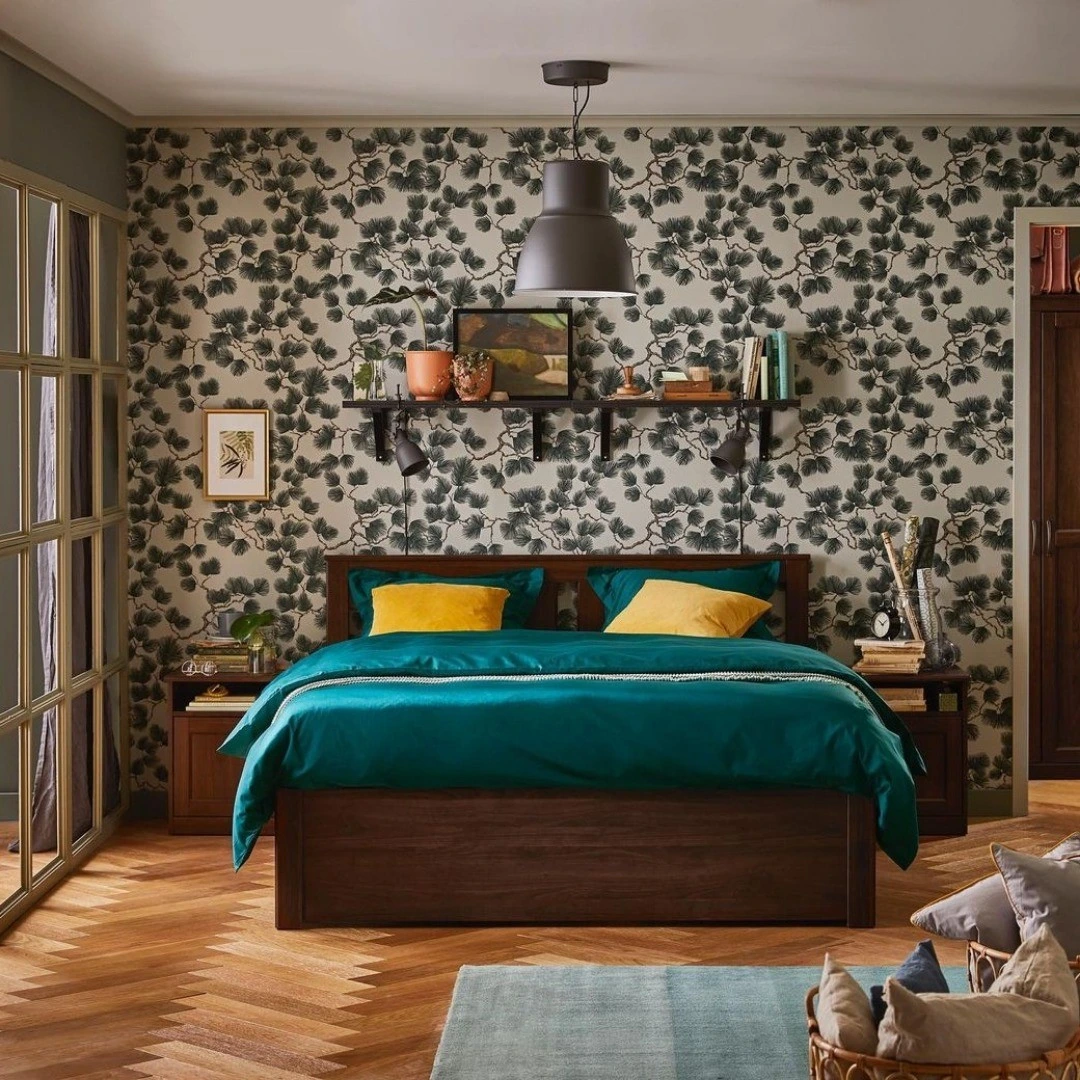 Modern bedroom with botanical wallpaper and dark wood furniture.