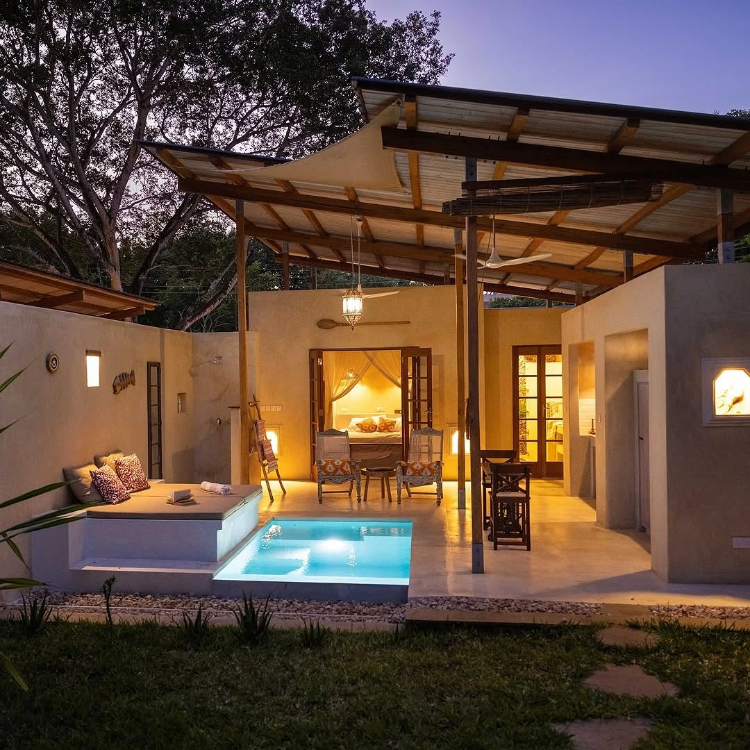 Bedroom opening to a romantic courtyard with a small pool.