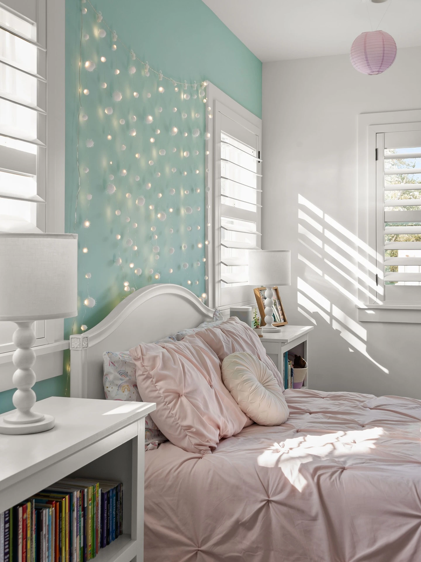 Fairy light adorned bedroom with pastel colors.