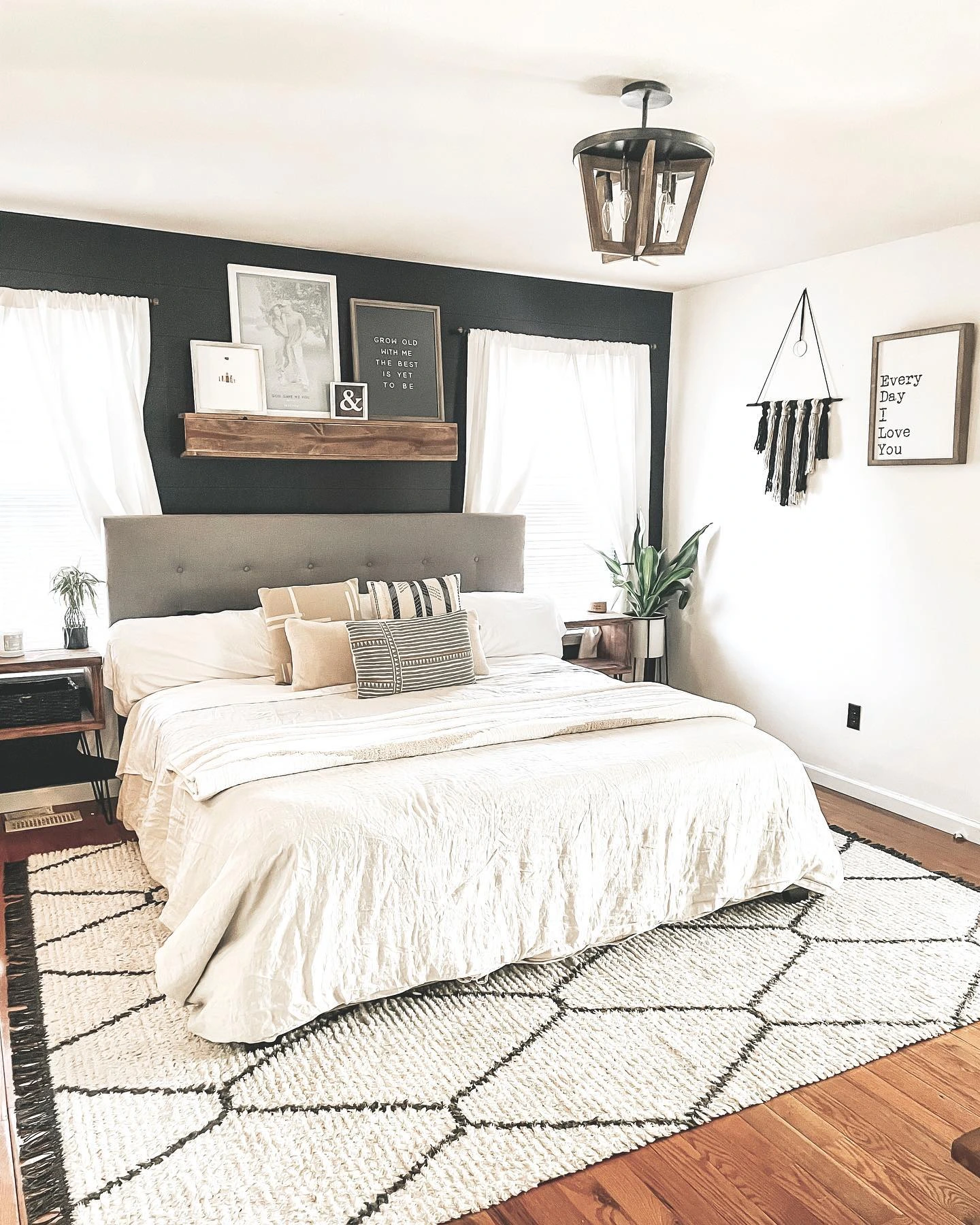 Bed with a gallery wall above the headboard.  