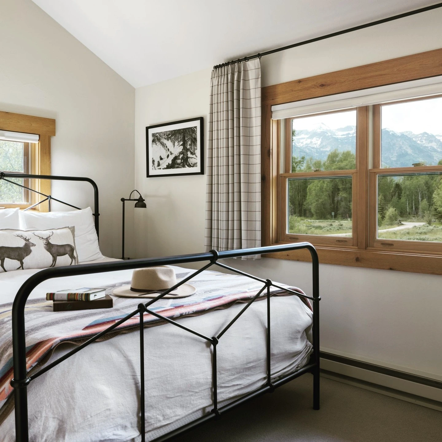 Rustic bedroom with a black metal bed frame.  