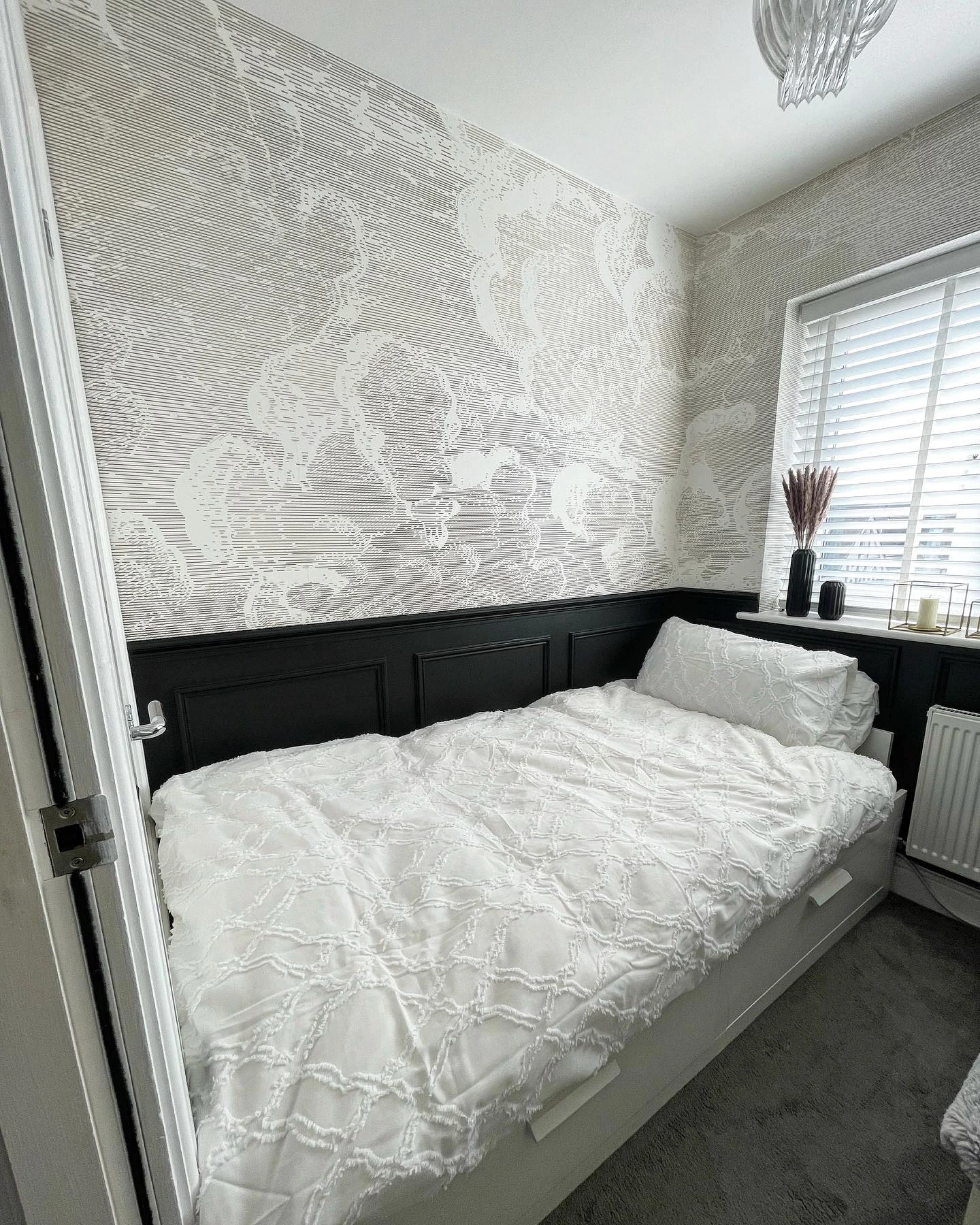 Wall with both wallpaper and wainscoting.  