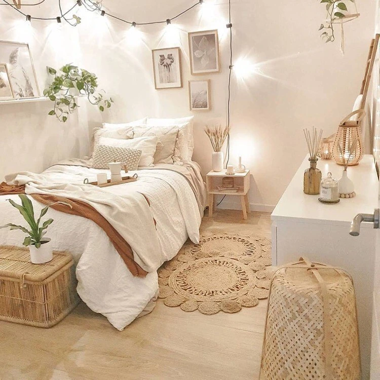 Bed with layered blankets and string lights.  