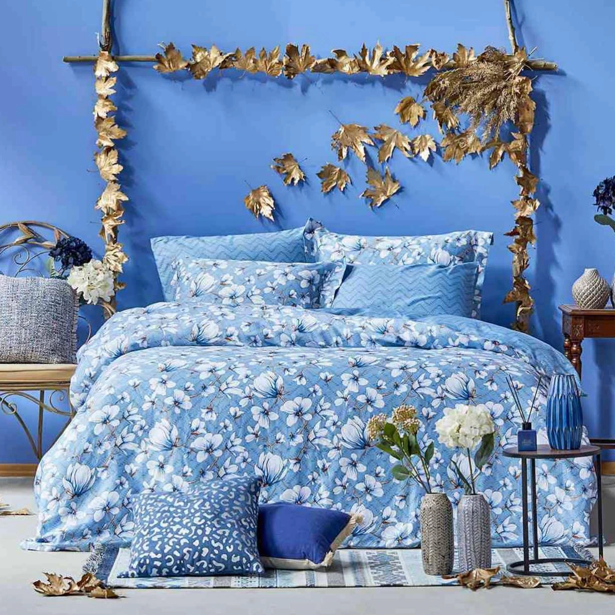 Bed with a blue floral comforter.  