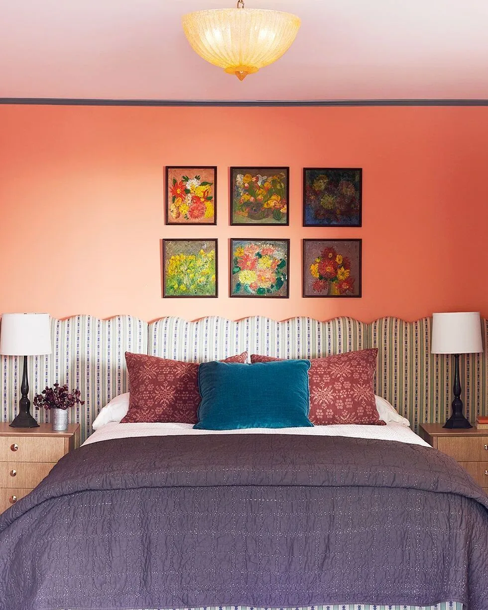 Small Bedroom Color Ideas: Vibrant coral wall with colorful art