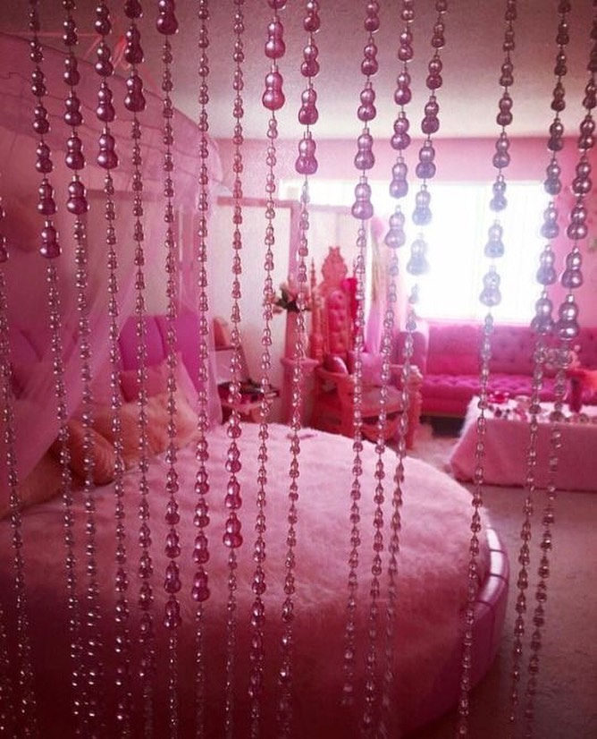 Pink-themed bedroom with bead curtains  