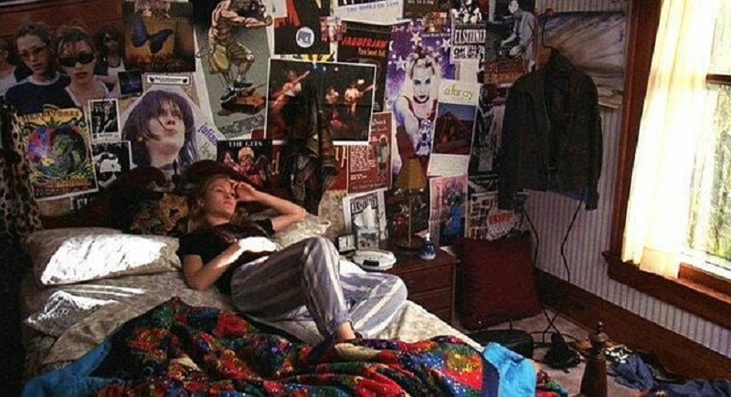 Moody poster-filled bedroom  